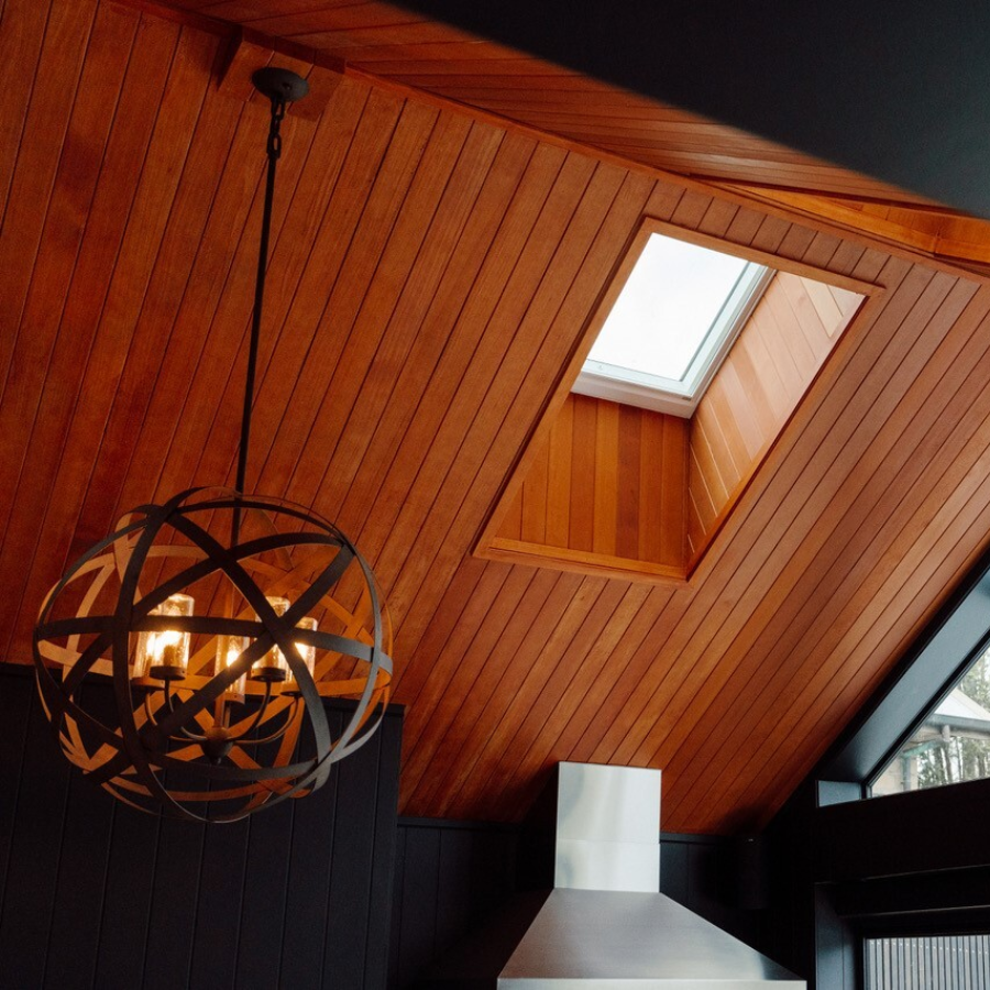 JSC's Alaskan Yellow Cedar ceiling coated in JSC Scumble Desert with light feature contrast against black interior walls by Transform Construction