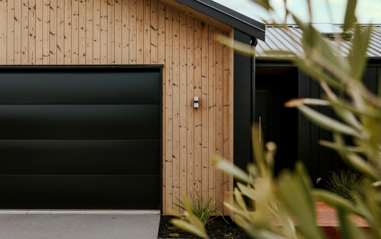 Mcbrimar Show Home 9 | Featuring TMT (Thermally Modified Timber) Taiga on Garage door in VertiClad profile | JSC | Timber Cladding